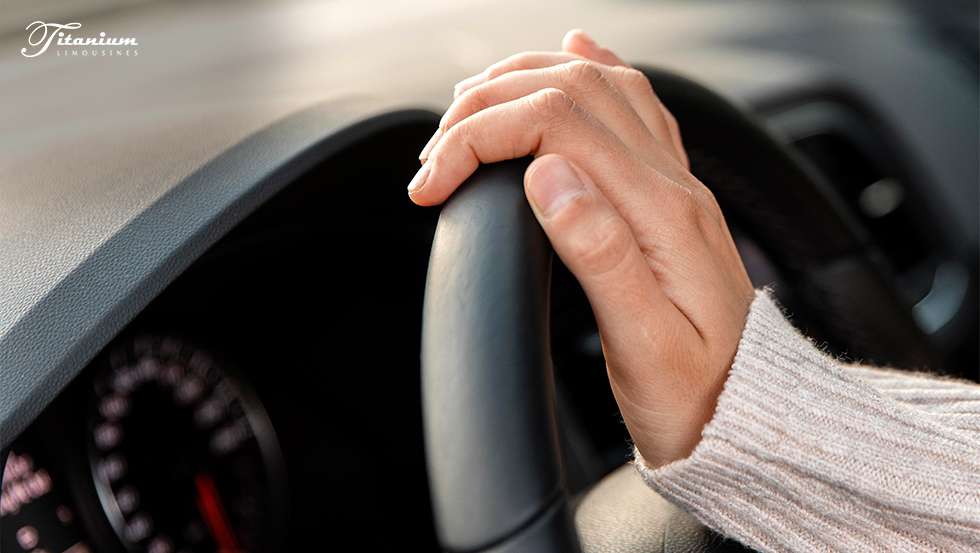 Image of a hand driving a car